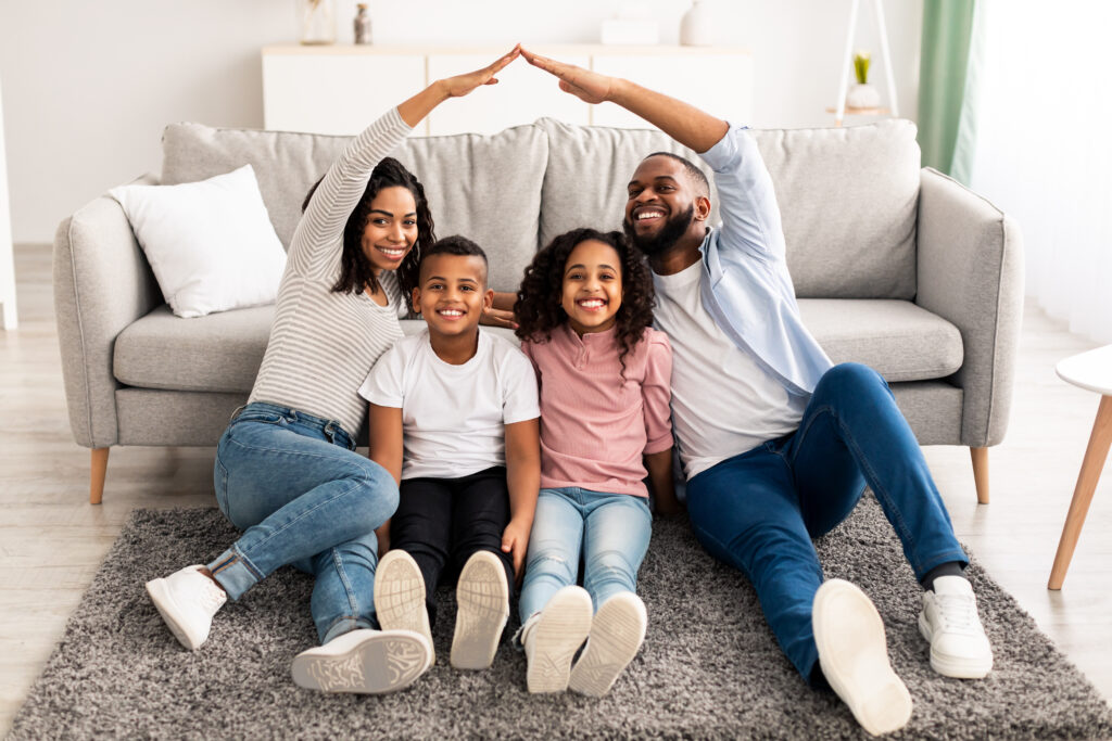 Black parents making symbolic roof of hands above their children